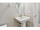 Neutral powder room featuring pedestal sink, white walls, elongated toilet, and chrome fixtures at 2432 Golden Pasture Cir, Clearwater, FL 33764