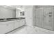 Stylish bathroom with double vanity, a large mirror, and a glass enclosed shower with marble-look tile at 2432 Golden Pasture Cir, Clearwater, FL 33764