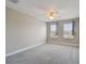 Bedroom featuring neutral carpet, ceiling fan and two bright windows at 2432 Golden Pasture Cir, Clearwater, FL 33764