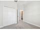 Neutral bedroom with carpeted floors, a double door closet, and a light-filled atmosphere leading to Laundry Room at 2432 Golden Pasture Cir, Clearwater, FL 33764