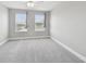 Bedroom featuring neutral carpet and two bright windows at 2432 Golden Pasture Cir, Clearwater, FL 33764
