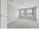 Bright bedroom with neutral carpet, ceiling fan and two windows at 2432 Golden Pasture Cir, Clearwater, FL 33764