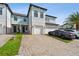 Beautiful townhome exterior featuring a brick driveway and a two-car garage at 2432 Golden Pasture Cir, Clearwater, FL 33764