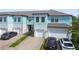 Stylish townhome exterior with blue siding, brick driveway, and attached garage at 2432 Golden Pasture Cir, Clearwater, FL 33764