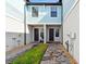 Charming townhome entrance with a paved walkway and well-maintained landscaping at 2432 Golden Pasture Cir, Clearwater, FL 33764