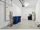 Clean garage features automatic garage door, epoxy flooring, water heater and multiple city trash bins at 2432 Golden Pasture Cir, Clearwater, FL 33764