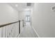 Hallway with a wooden banister and gray carpet at 2432 Golden Pasture Cir, Clearwater, FL 33764