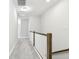 Neutral-toned hallway with plush carpeting and traditional wood and white railing at 2432 Golden Pasture Cir, Clearwater, FL 33764