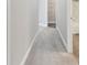 A hallway with gray carpet leads to other rooms in the home at 2432 Golden Pasture Cir, Clearwater, FL 33764