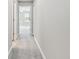 Hallway with carpet flooring leading to a bright room at 2432 Golden Pasture Cir, Clearwater, FL 33764