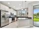 Modern kitchen with stainless steel appliances and sliding glass doors to backyard at 2432 Golden Pasture Cir, Clearwater, FL 33764