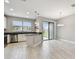 Bright kitchen with stainless steel appliances and sliding glass doors to backyard at 2432 Golden Pasture Cir, Clearwater, FL 33764