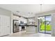 Stylish kitchen with stainless steel appliances and sliding glass doors to backyard at 2432 Golden Pasture Cir, Clearwater, FL 33764