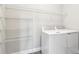 Clean laundry room featuring modern appliances and spacious shelving for efficient organization at 2432 Golden Pasture Cir, Clearwater, FL 33764