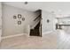 Open concept living area with wood-look tile flooring and a staircase at 2432 Golden Pasture Cir, Clearwater, FL 33764