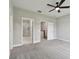 The main bedroom has gray walls and carpet and multiple access doors at 2432 Golden Pasture Cir, Clearwater, FL 33764