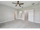 A spacious main bedroom with neutral walls, a ceiling fan and gray carpeting at 2432 Golden Pasture Cir, Clearwater, FL 33764