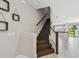 Inviting staircase with wood steps, white risers, and an open floorplan that leads into the kitchen and living areas at 2432 Golden Pasture Cir, Clearwater, FL 33764