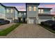 Charming townhome exterior with private garages and a well-maintained front yard, providing curb appeal at 2432 Golden Pasture Cir, Clearwater, FL 33764