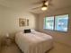 Comfortable bedroom with a ceiling fan and a large window for natural light at 2541 Laurelwood Dr # 8C, Clearwater, FL 33763