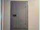 A gray electrical panel mounted on a wall, ensuring safe and reliable power distribution throughout the house at 2541 Laurelwood Dr # 8C, Clearwater, FL 33763