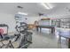 Spacious gym features exercise equipment, tv, and a billiards table for recreation at 2541 Laurelwood Dr # 8C, Clearwater, FL 33763