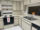 Well-maintained kitchen showcasing light cabinets and countertops with stainless steel sink at 2541 Laurelwood Dr # 8C, Clearwater, FL 33763