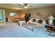 Open-concept living room with view into kitchen featuring dining area, sitting area and plush carpeting at 2541 Laurelwood Dr # 8C, Clearwater, FL 33763