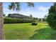 Lush backyard featuring a well-maintained lawn and a screened-in pool for outdoor enjoyment at 26 Concord Dr, Dunedin, FL 34698