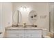 Elegant bathroom showcasing double vanities, granite countertops, and modern fixtures at 26 Concord Dr, Dunedin, FL 34698