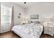 Bright bedroom with large bed, side tables and wooden floors at 26 Concord Dr, Dunedin, FL 34698