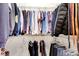 Neatly organized closet with hanging shirts, jackets and jeans at 26 Concord Dr, Dunedin, FL 34698