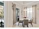 Cozy dining area with modern lighting, seating for four, and sliding glass doors to the screened patio at 26 Concord Dr, Dunedin, FL 34698