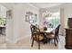 Elegant dining room with a chandelier, classic furniture, and natural light at 26 Concord Dr, Dunedin, FL 34698