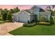 Beautiful single Gathering home with a three car garage, lovely landscaping, and brick paver driveway at 26 Concord Dr, Dunedin, FL 34698