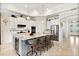Spacious kitchen features white cabinetry, stainless steel appliances, a large center island, and bar stool seating at 26 Concord Dr, Dunedin, FL 34698