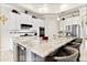 Modern kitchen featuring white cabinets, stainless appliances, a spacious island, and bar stool seating at 26 Concord Dr, Dunedin, FL 34698