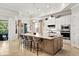 Gourmet kitchen featuring a large island with seating, stainless steel appliances, and access to the backyard at 26 Concord Dr, Dunedin, FL 34698