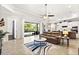 Open-concept living room seamlessly connects to the kitchen and patio, with a plush sofa and stylish decor at 26 Concord Dr, Dunedin, FL 34698