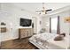 Spacious main bedroom featuring hardwood floors, a ceiling fan, and a large dresser at 26 Concord Dr, Dunedin, FL 34698