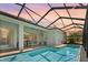 Covered pool with screen enclosure and outdoor seating to enjoy in this beautifully built home at 26 Concord Dr, Dunedin, FL 34698