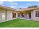 Backyard patio area with multiple sliding glass doors providing lots of natural light to the interior at 2728 Abbey Grove Dr, Valrico, FL 33594