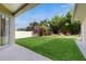 A large, manicured backyard lawn leads to a beautiful garden filled with mature trees, bamboo and flowering bushes at 2728 Abbey Grove Dr, Valrico, FL 33594