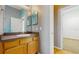 Bathroom featuring light gray walls and a wood vanity with a gray countertop at 2728 Abbey Grove Dr, Valrico, FL 33594