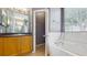 Bathroom showcases a bathtub and wood vanity with a granite counter top at 2728 Abbey Grove Dr, Valrico, FL 33594