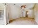 Bedroom featuring neutral carpet, ceiling fan, access to bath and sliding glass doors at 2728 Abbey Grove Dr, Valrico, FL 33594