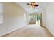 Relaxing bedroom with neutral carpet, a ceiling fan, and sliding glass doors to outside at 2728 Abbey Grove Dr, Valrico, FL 33594