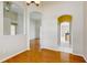 Elegant dining room featuring wood floors, an open layout, and arched entryways to the living spaces at 2728 Abbey Grove Dr, Valrico, FL 33594