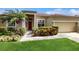 Charming single-story home with a red front door, lush landscaping, and a well-maintained lawn at 2728 Abbey Grove Dr, Valrico, FL 33594