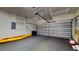 Garage with kayak, storage and a rolling garage door at 2728 Abbey Grove Dr, Valrico, FL 33594
